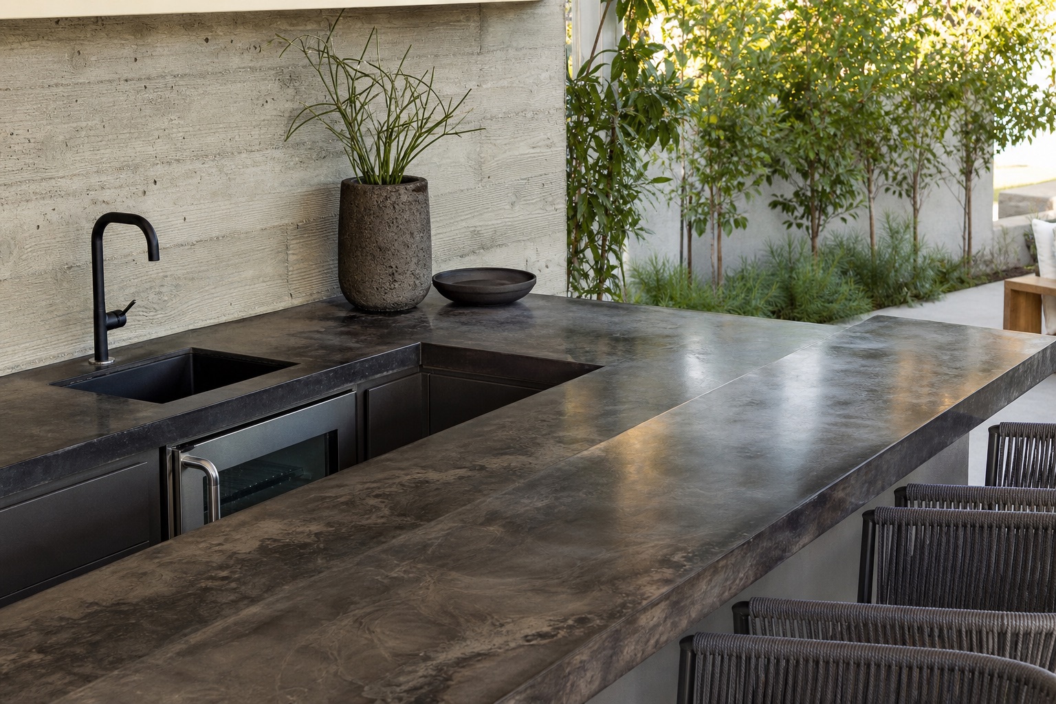 Custom graphite resin bar surface with realistic edge treatment in a modern outdoor residential setting